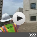 Construction worker in front of building